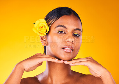 Buy stock photo Woman, rose and natural beauty for skincare, dermatology and cosmetics portrait on yellow background. Spring, eco friendly treatment for self care, facial for antiaging with flower and glow in studio
