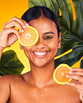 Woman, orange and beauty with natural skincare, dermatology and cosmetics portrait on yellow background. Monstera, citrus fruit and vegan treatment, green facial for vitamin c and skin glow in studio