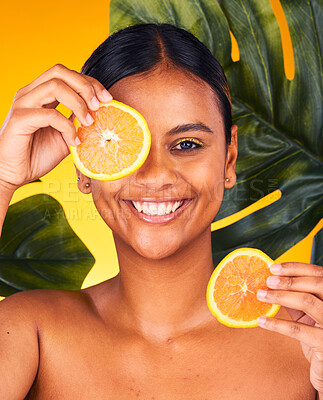 Buy stock photo Woman, orange and beauty with natural skincare, dermatology and cosmetics portrait on yellow background. Monstera, citrus fruit and vegan treatment, green facial for vitamin c and skin glow in studio