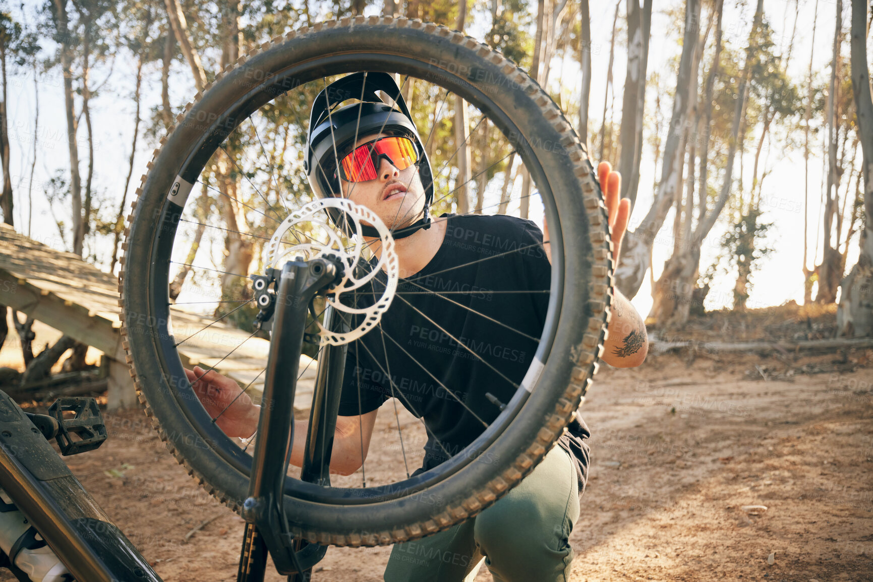 Buy stock photo Nature, man and bike with tire repair, wheel change or maintenance on broken bicycle in forest for workout. Person, cycling and inspection before exercise, training or adventure in woods or path 