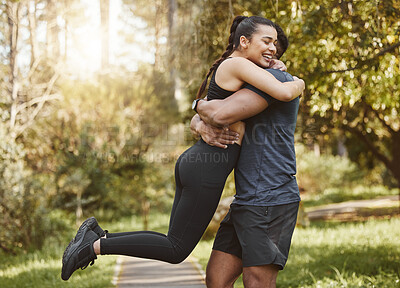 Buy stock photo Fitness, nature and couple hug and spinning outdoors for exercise, training and running for cardio workout. Dating, happy and interracial man and woman embrace for wellness, healthy body and sports