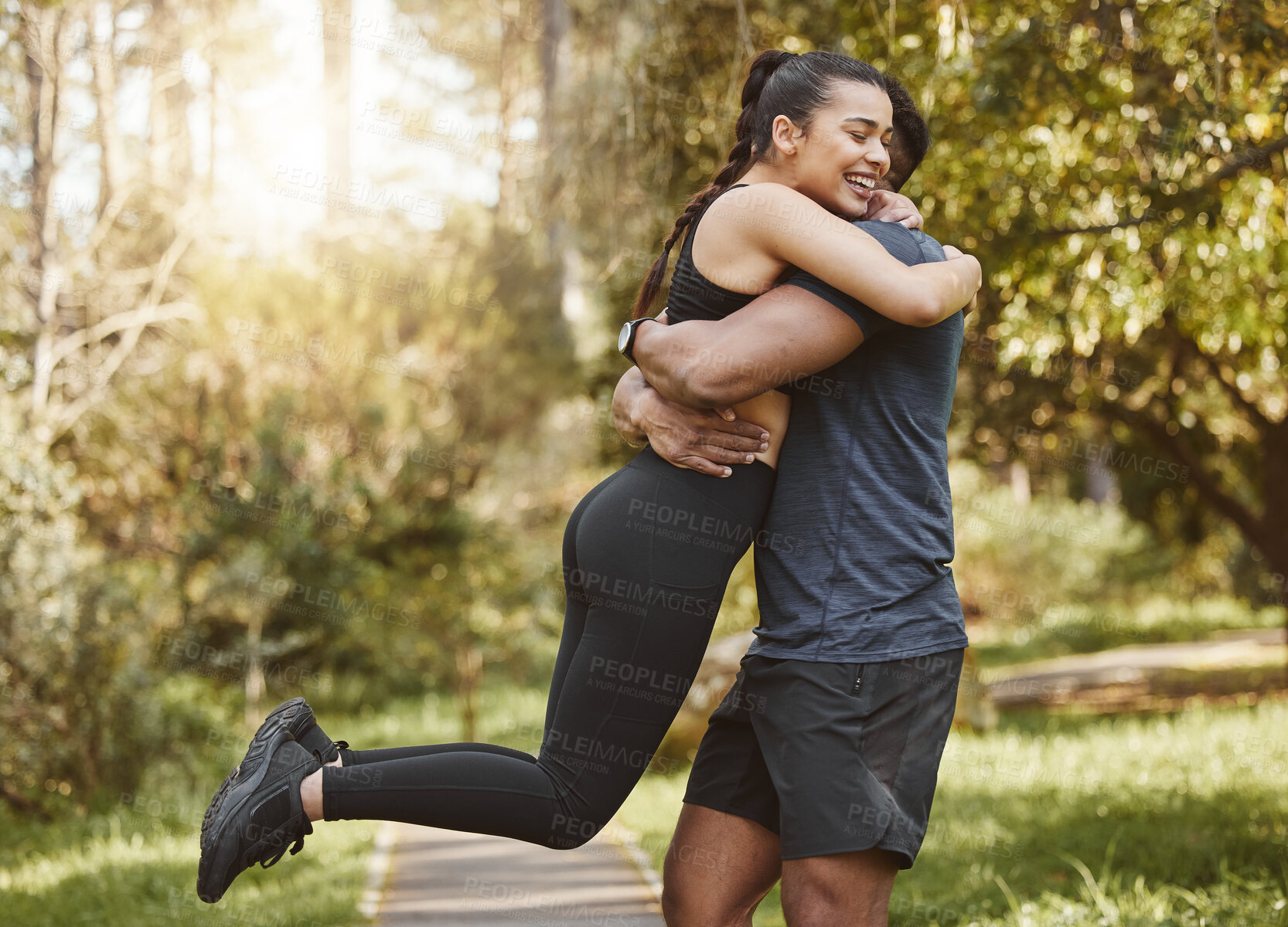 Buy stock photo Fitness, nature and couple hug and spinning outdoors for exercise, training and running for cardio workout. Dating, happy and interracial man and woman embrace for wellness, healthy body and sports