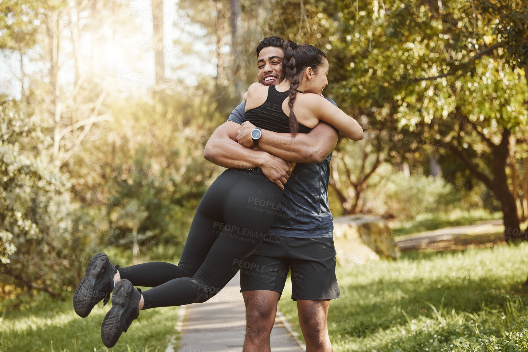 Buy stock photo Fitness, spinning and couple hug in park outdoors for exercise, training and running for cardio workout. Dating, happy and interracial man and woman embrace for wellness, healthy body and sports
