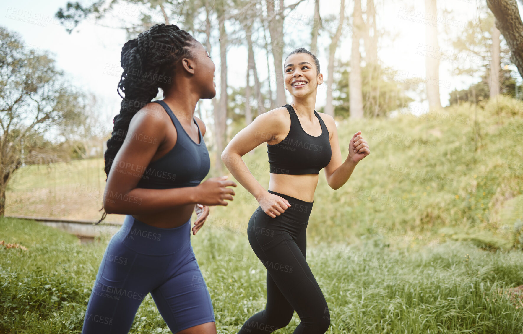 Buy stock photo Happy woman, friends and running in forest for workout, training or outdoor cardio exercise together. Active female person, athlete or runners smile for sports run, sprint or race in nature fitness