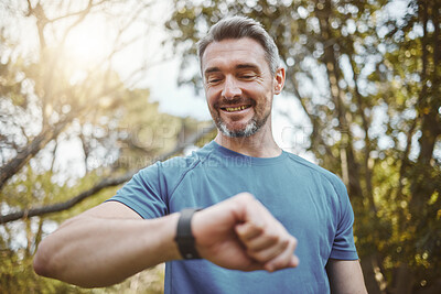 Buy stock photo Happy runner man, smart watch and park for check, smile or reading for time, results or fitness in nature. Person, iot clock and monitor for speed, heart rate or smile for exercise, workout or health