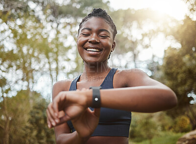 Buy stock photo African runner woman, smart watch and park for check, smile or happy for time, results or fitness in nature. Girl, iot clock and monitor for speed, heart rate or smile for exercise, workout or health