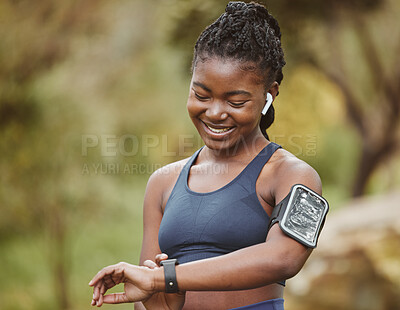 Buy stock photo Fitness, smart watch and woman tracking performance on outdoor exercise, workout or training in a forest. Heart rate, wellness and young black person ready and listening to music, audio or podcast