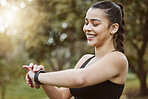 Happy runner woman, smart watch and park for check, smile or reading for time, results or fitness in nature. Girl, iot clock and monitor for speed, heart rate or smile for exercise, workout or health