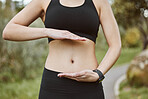 Woman, hands and stomach in nature for lose weight, tai chi or spiritual wellness in outdoor exercise. Closeup of female person and abdomen for reiki, aura or balance in body care, fitness or park