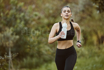Buy stock photo Woman, water bottle and running in nature for fitness, workout or outdoor exercise with hydration. Active person, athlete or runner and natural mineral drink for training, nutrition or sustainability