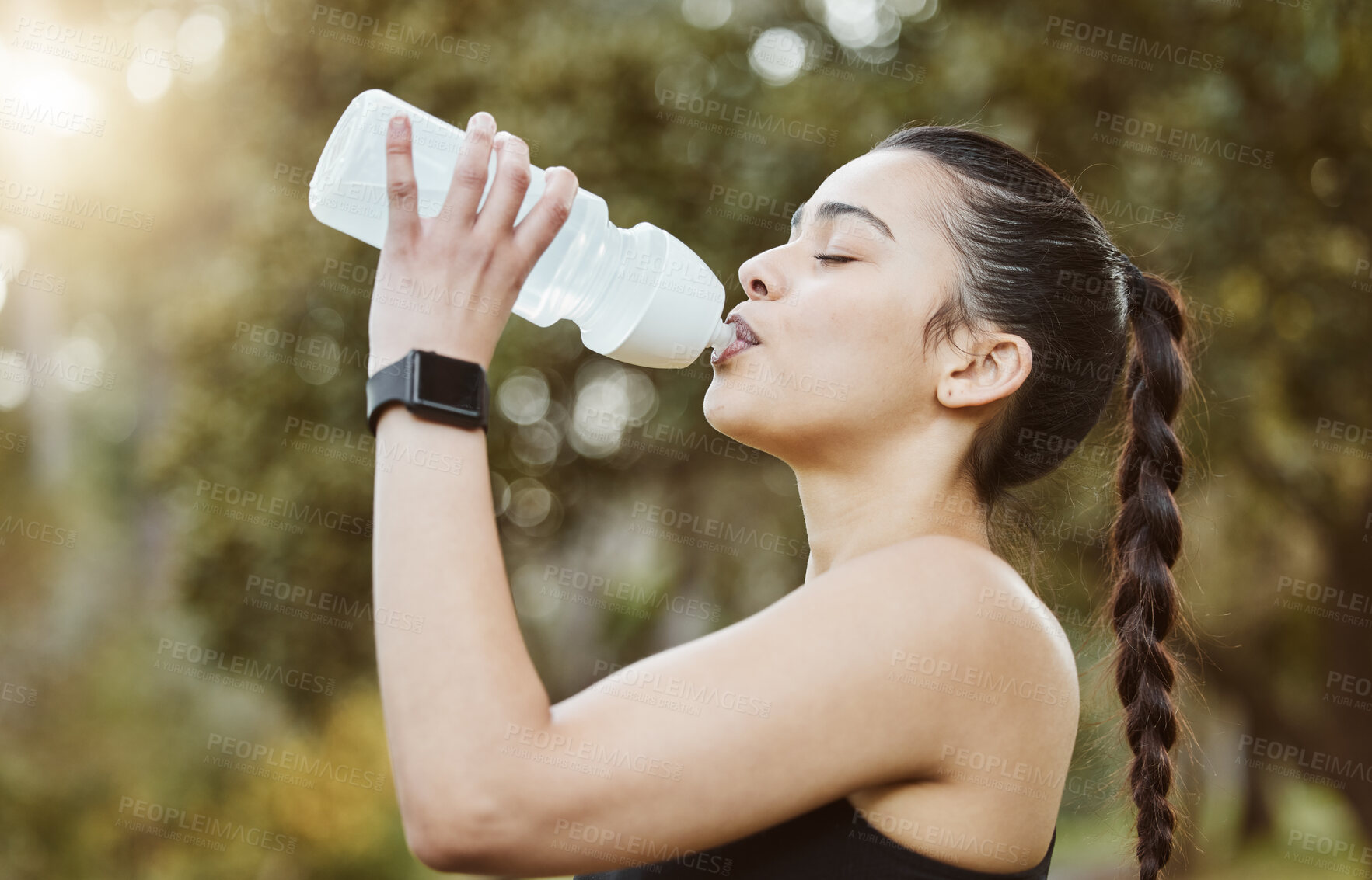 Buy stock photo Woman, fitness and drinking water in nature for hydration, natural nutrition or sustainability. Thirsty runner person with mineral drink or bottle in rest after workout, exercise or outdoor training