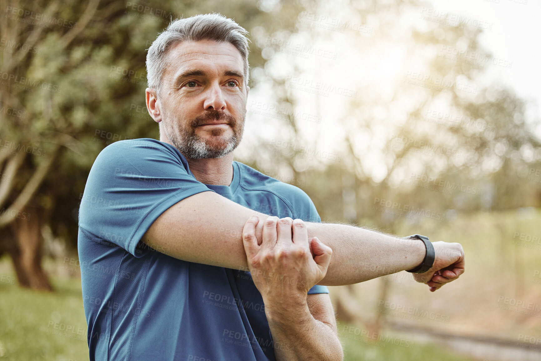 Buy stock photo Mature man, arm stretching and outdoor for fitness, wellness and exercise in a park for health. Morning, athlete and training in nature with workout and sports of a calm person ready to start run