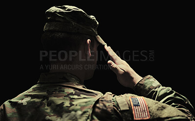 Buy stock photo Back, salute and army with a soldier in uniform on a dark background in studio for service or duty as a patriot. Military, respect and america marine or war veteran from behind, ready for battle