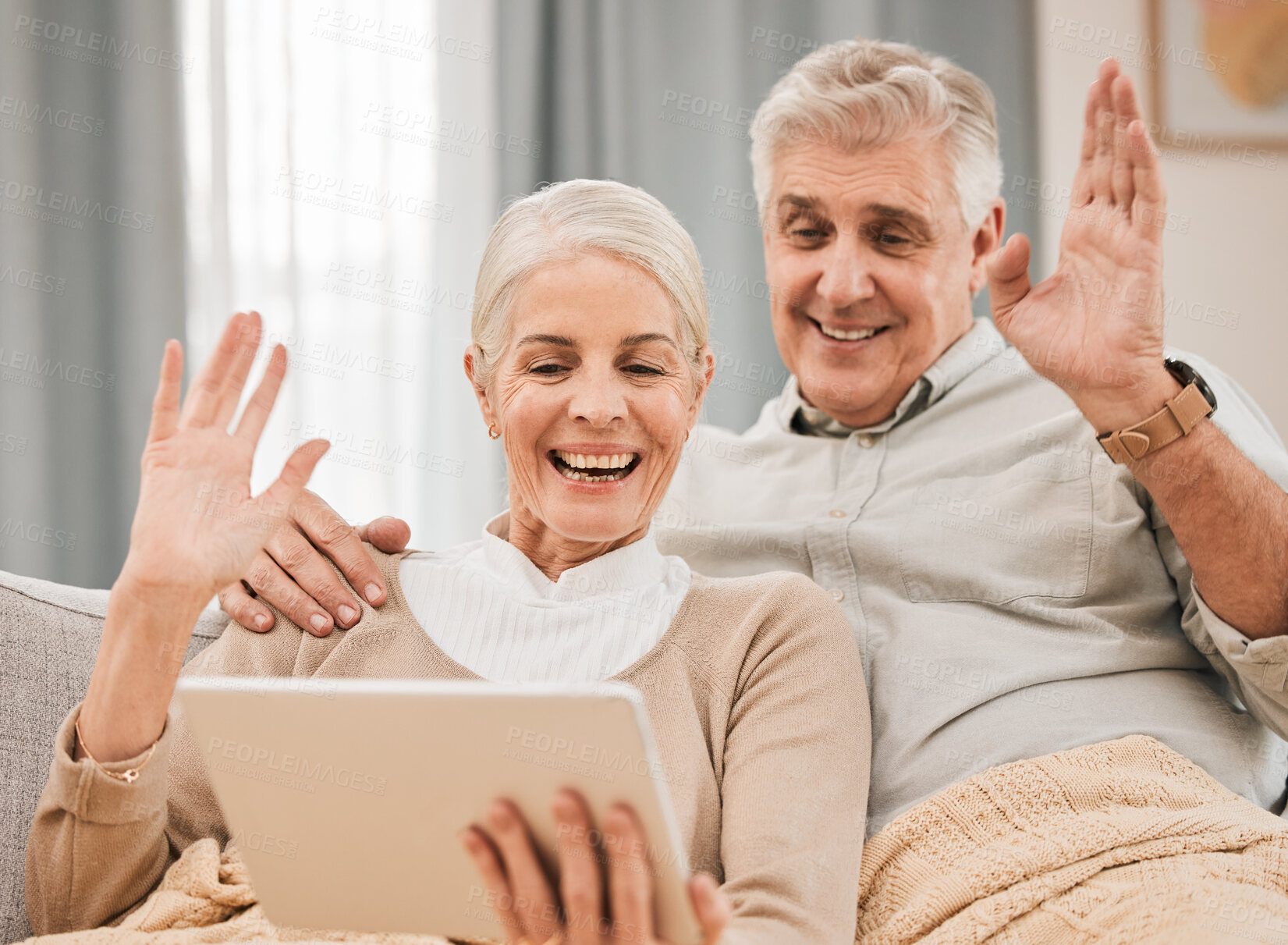 Buy stock photo Home, video call and old couple with a tablet, wave and hello with connection, social media or retirement. Technology, elderly man or senior woman on a couch, network or online chatting with greeting