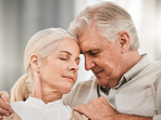 Old couple, hug and forehead touch, relax on sofa with love and support, bonding while at home with trust and comfort. People together in marriage, partner and retirement with calm and peace of mind