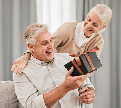 Buy stock photo Happy couple, together and surprise with gift at house for retirement, birthday or anniversary on vacation. Elderly, man and woman in celebration of event with happiness, love and care for partner