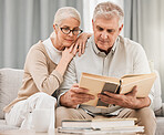 God, worship and senior couple with bible on a sofa relax with scripture, study or reading in their home. Holy, book and retired people in a living room with gospel, faith and Jesus Christ praise