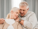 Old people, hug and relax on sofa with love and support, bonding while at home with trust and comfort. Couple with time together, marriage or life partner with retirement, calm and peace of mind