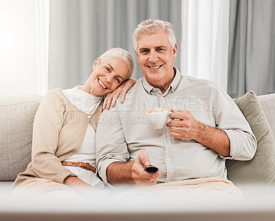 Buy stock photo Old couple, happy on couch with coffee and watching tv, time together in retirement, bonding and love at home. People relax with online streaming, subscription and remote control with tea and a show