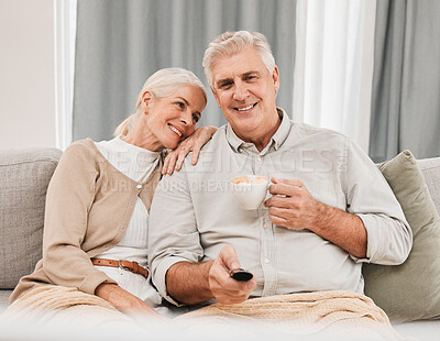 Buy stock photo Old couple, home and watching tv with coffee and happiness together in retirement, partner and remote control. Love, care and online streaming, tv show with tea and people relax on couch for movie