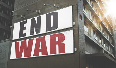 Buy stock photo Billboard, poster and information on building, wall and war, propaganda or advertising activism campaign in city. End, conflict and sign or banner to protest politics, violence or global crisis