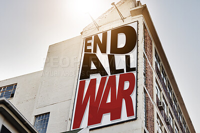 Buy stock photo Building, billboard and poster with information on wall with war, propaganda or advertising activism campaign in city. End, conflict and sign or banner to protest politics, violence or global crisis