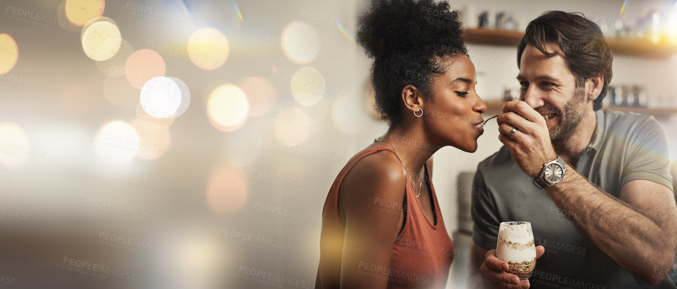 Buy stock photo Love, dessert and feeding with a couple on space in their home together for romance or dating. Smile, mockup or banner with an interracial man and woman eating in the kitchen on their anniversary