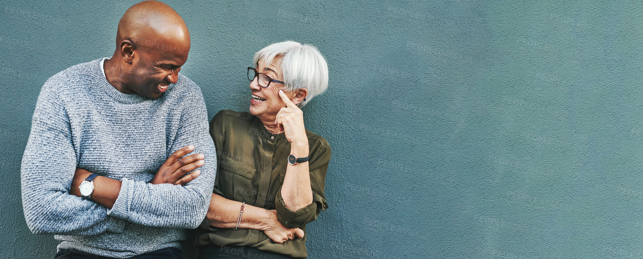 Buy stock photo Business people, conversation and staff on wall background, planning and funny with mockup space. Black man, woman and workers with happiness, discussion and brainstorming with humor, joke and ideas