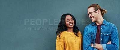 Buy stock photo Happy, conversation and couple by wall with mockup space for advertising, promotion or marketing. Smile, talking and young interracial man and woman in discussion together by gray background mock up.