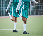 Team, stretching legs and exercise on field, sports and uniform for match, balance and teamwork together. Diverse group of athletes, outdoor and fitness to prepare for game, workout for performance