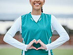Healthy, heart hands or happy athlete on field for fitness, exercise or workout for cardiovascular health. Love sign, hand gesture or sports woman in a training game for wellness or hockey practice