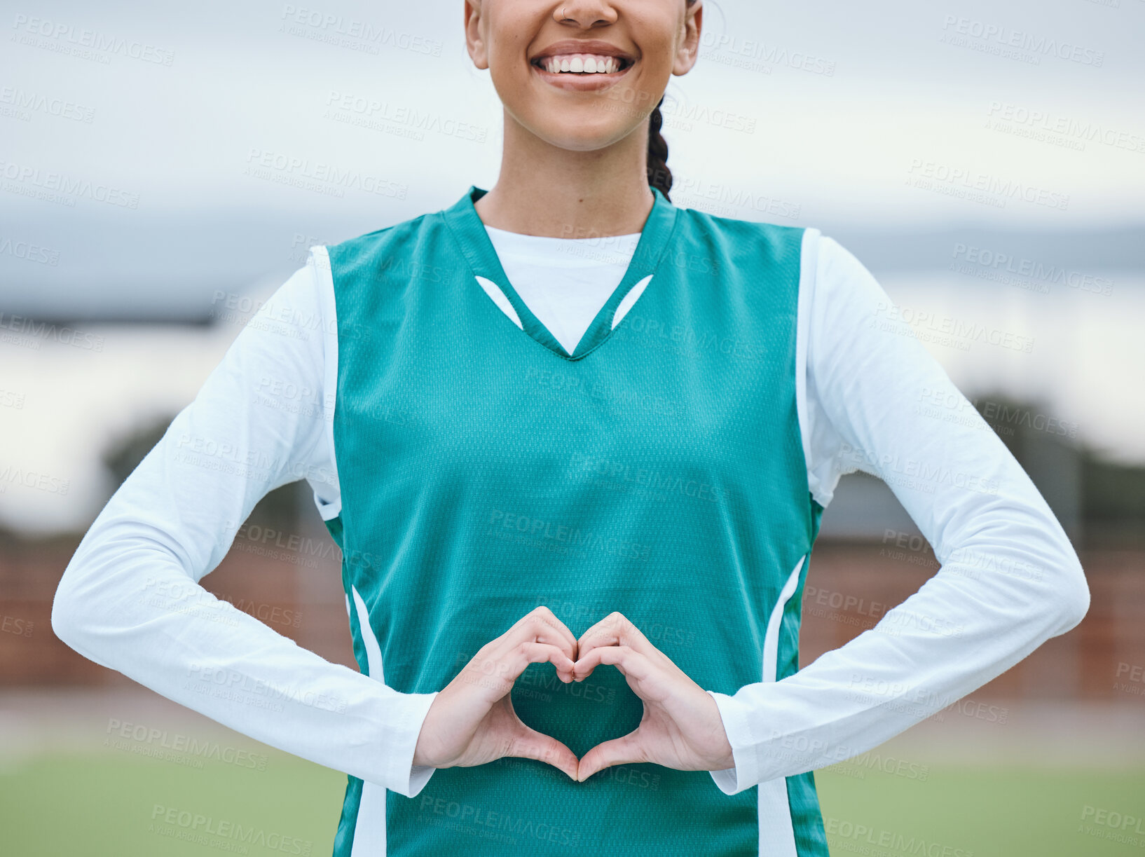 Buy stock photo Healthy, heart hands or happy athlete on field for fitness, exercise or workout for cardiovascular health. Love sign, hand gesture or sports woman in a training game for wellness or hockey practice