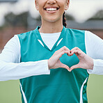 Sports, heart hands or happy athlete on field for fitness, exercise or workout for cardiovascular health. Love sign, hand gesture or healthy woman in a training game for wellness or hockey practice