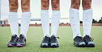 Legs, shoes and woman hockey team outdoor on a field for a game or competition together in summer. Fitness, training or sports with people on a pitch of a grass for exercise or teamwork on match day