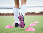 Cone, legs or athlete running in sports training, workout and warm up exercise on a outdoor hockey turf. Footwear closeup, back or fast person on grass pitch playing in a game for fitness speed