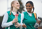 Happy, team sports or women in conversation on turf or court for break after fitness, training or exercise. Smile, funny girl or female hockey players walking, laughing or talking to relax together