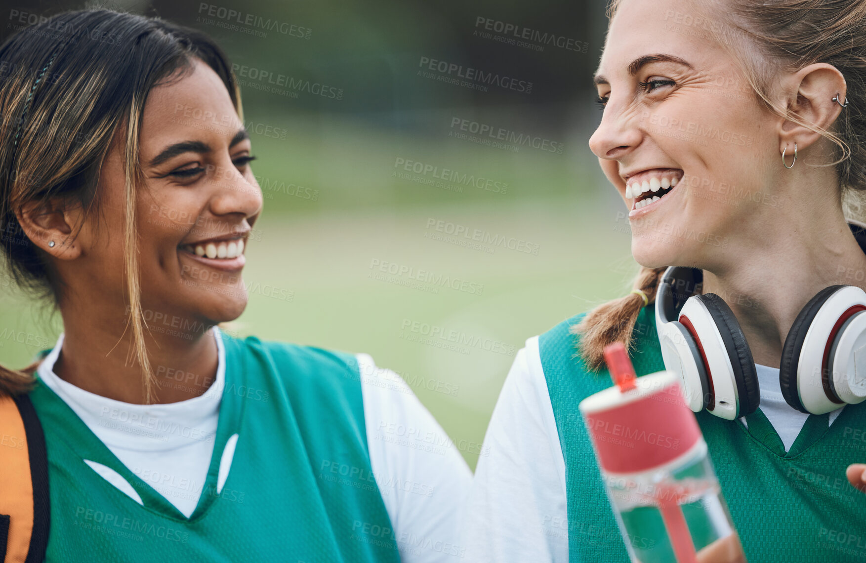 Buy stock photo Laughing, team sports or women in conversation on turf or court for break after fitness training or exercise. Smile, happy friends or funny female hockey players speaking or talking to relax together