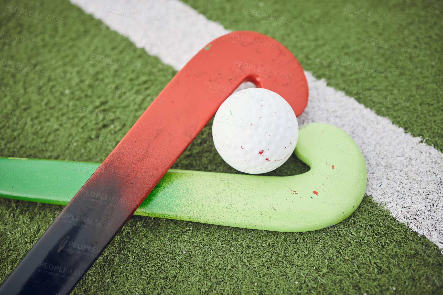 Buy stock photo Hockey, stick and ball on green, field or pitch with sports equipment for game, competition or match on ground or floor. Artificial grass, heart or gear on turf for training in sport championship