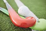 Field, hockey and stick with ball on green, pitch or sports equipment for game, competition or match on ground or floor. Grass, turf or gear for sport or training for championship on astroturf