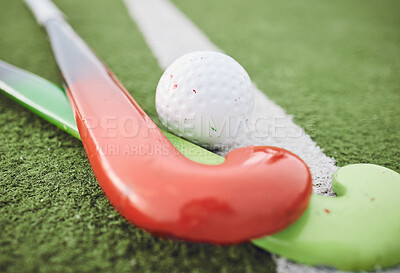 Buy stock photo Field, hockey and stick with ball on green, pitch or sports equipment for game, competition or match on ground or floor. Grass, turf or gear for sport or training for championship on astroturf