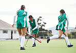 Hockey, group and women with fitness, game and training with competition, wellness and workout. People, players and girls playing, equipment or practice on a field, exercise and support with teamwork