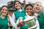 Sports women, team and trophy for success in portrait, celebration or winning competition on field. Champion girl group, friends and diversity for hockey, goal or happy outdoor at stadium for contest