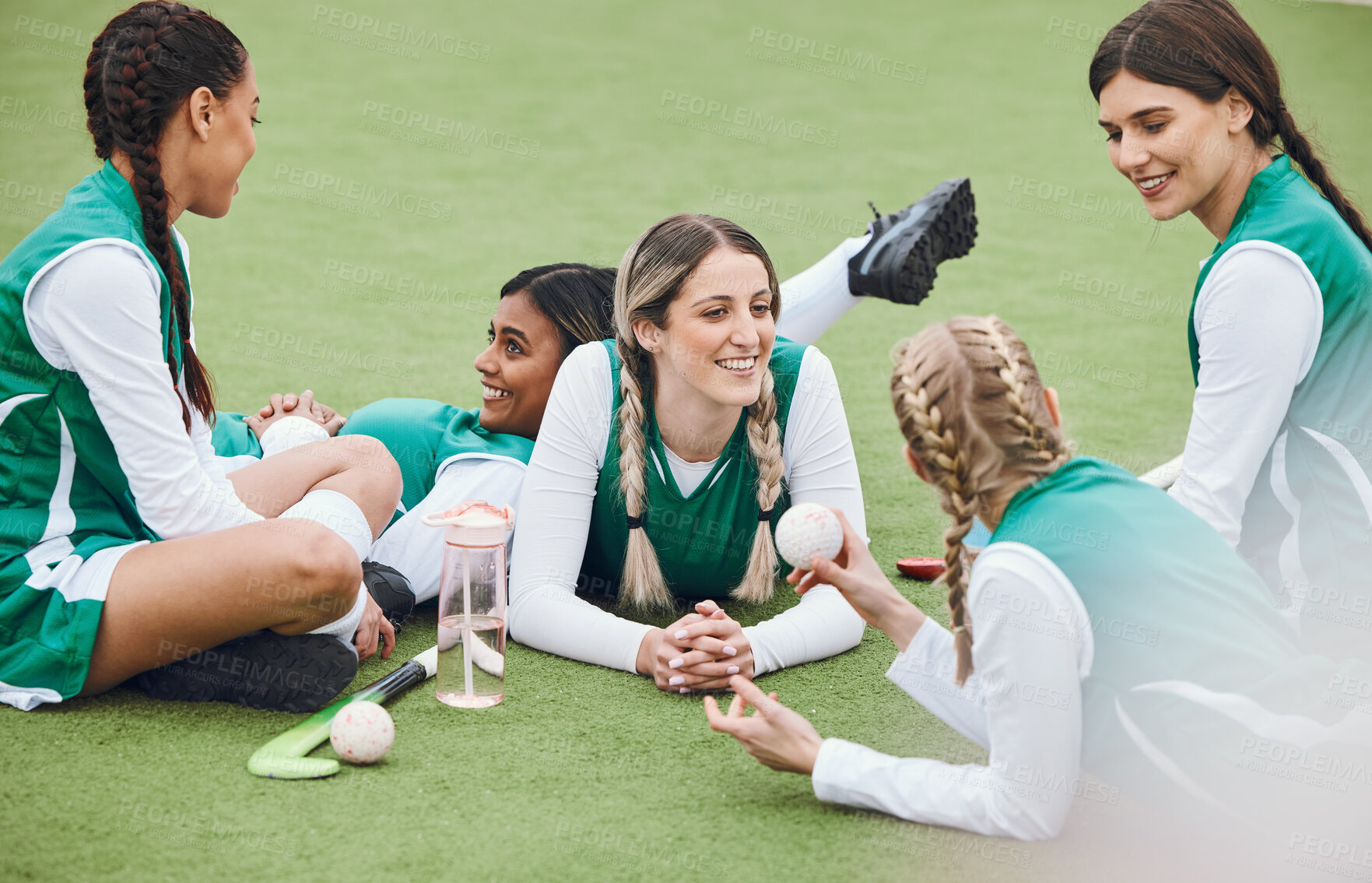 Buy stock photo Women, team and hockey player on field, talking and relaxing after match, smile and workout. Conversation, happiness and positive for sports, fitness and exercise together for unity, game and health