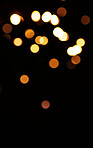 Gold, light and mockup with bokeh on dark background for New Year, Christmas or festive fireworks celebration at night. Mock up, space or sparkle in winter with magic, glow or shine on black backdrop