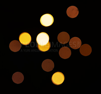 Buy stock photo Yellow, bokeh and lights or confetti in a studio with a dark background for celebration, event or party. Mockup, sparkle and gold for glow, magic or shine for festive by a black backdrop with mock up