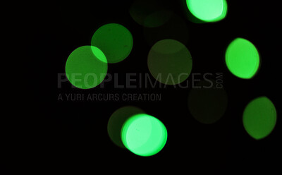 Buy stock photo Green, bokeh and light in a studio with a dark background for celebration, event or party. Mockup, sparkle and color for glow, magic or shine for festive decoration by a black backdrop with mock up.