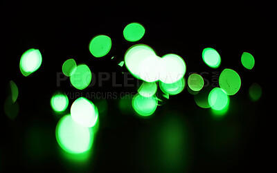 Buy stock photo Green, sparkles and bokeh in a studio with dark background for celebration, event or party. Confetti, glitter and color lights for magic, shine or glow for festive by black backdrop with mockup.