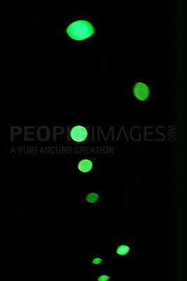 Buy stock photo Green light, bokeh and shine on dark background isolated on a mockup space. Blur, black backdrop and defocused glow, sparkle or glitter at night for Christmas, holiday or party with magic color dots