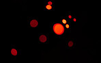 Red, bokeh and light in a studio with a dark background for celebration, event or party. Mockup, sparkle and color for glow, magic or shine for festive decoration by a black backdrop with mock up.