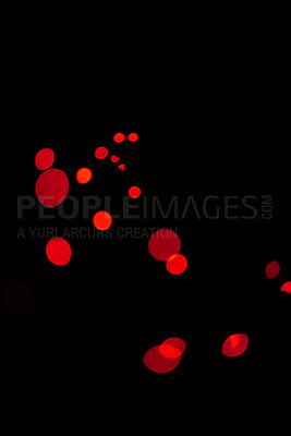 Bokeh, red dots and lights on black background with pattern, texture and mockup with cosmic aesthetic. Night lighting, sparkle particles and glow on dark wallpaper with space, color shine and flare.